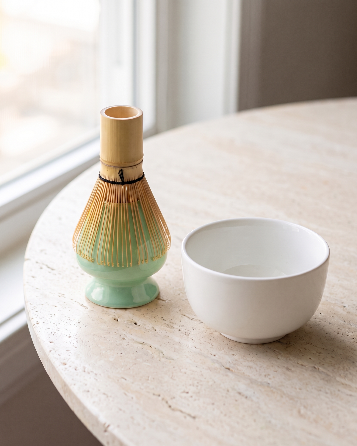 In use: Glossy Ceramic Whisk Holder – Mint, bamboo whisk resting prongs-down on the holder to dry