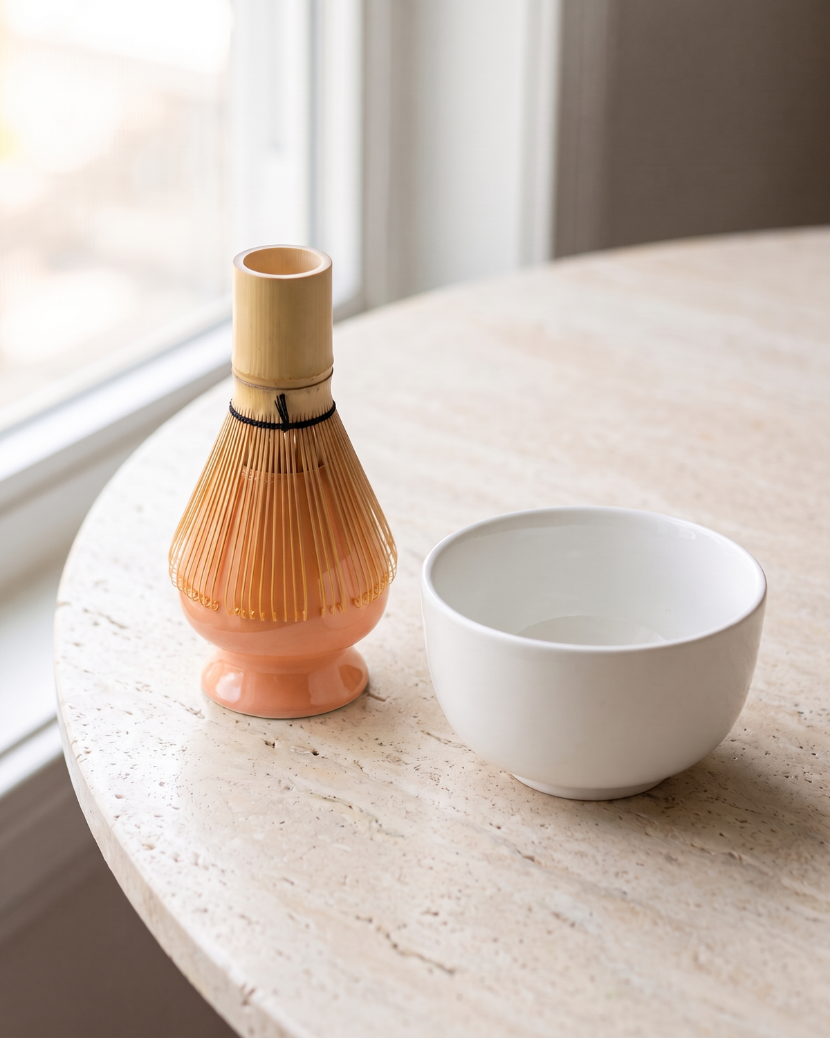 In use: Glossy Ceramic Whisk Holder – Peach, bamboo whisk resting prongs-down on the holder to dry