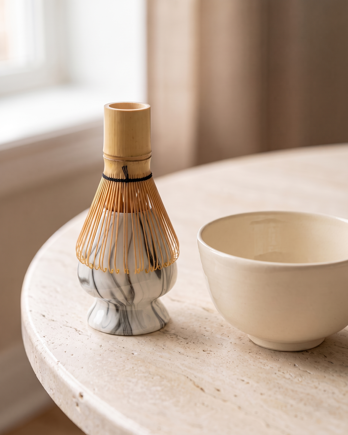 In use: Marble Ceramic Whisk Holder – Marble Black, bamboo whisk resting prongs-down on the holder to dry