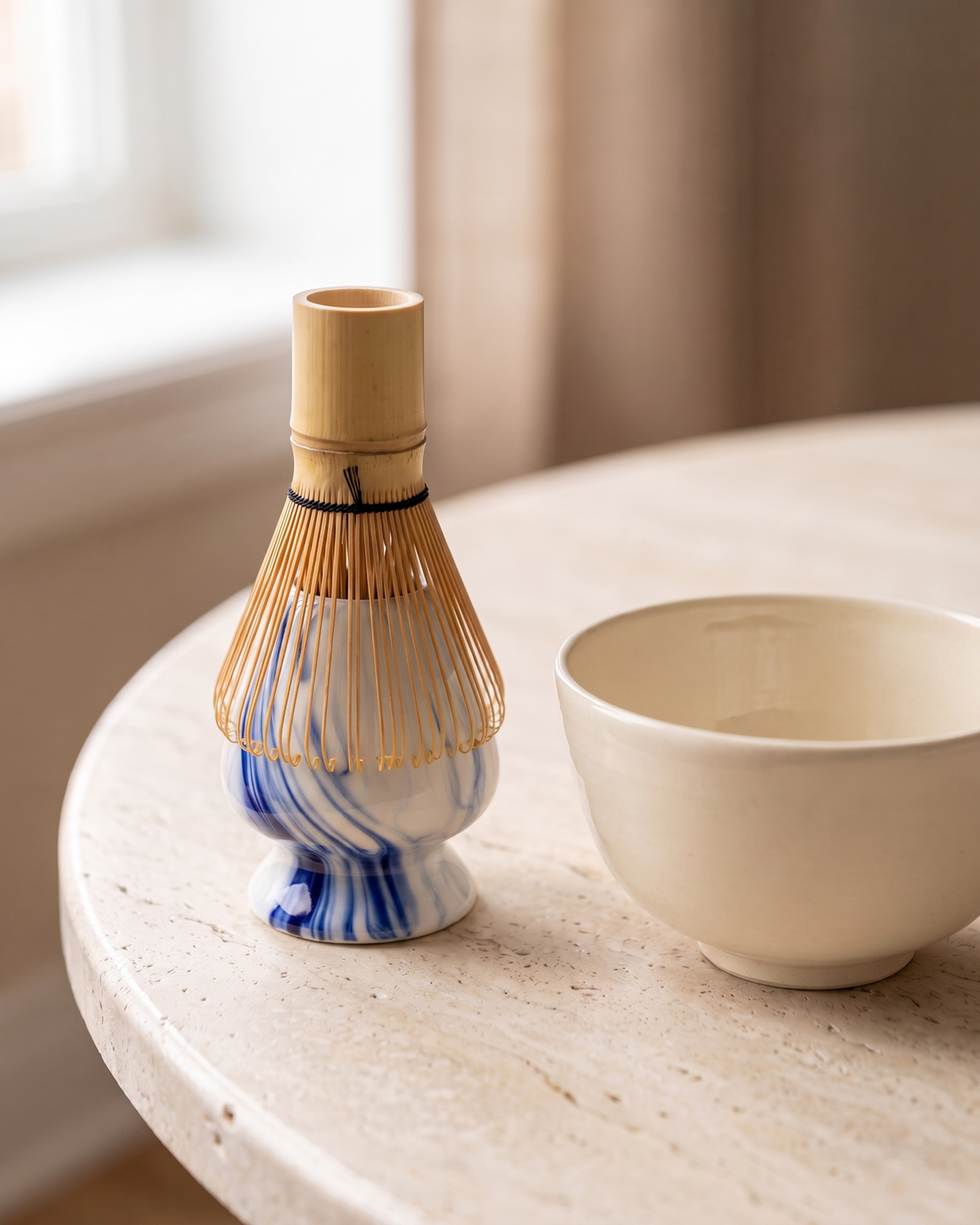 In use: Marble Ceramic Whisk Holder – Marble Blue, bamboo whisk resting prongs-down on the holder to dry