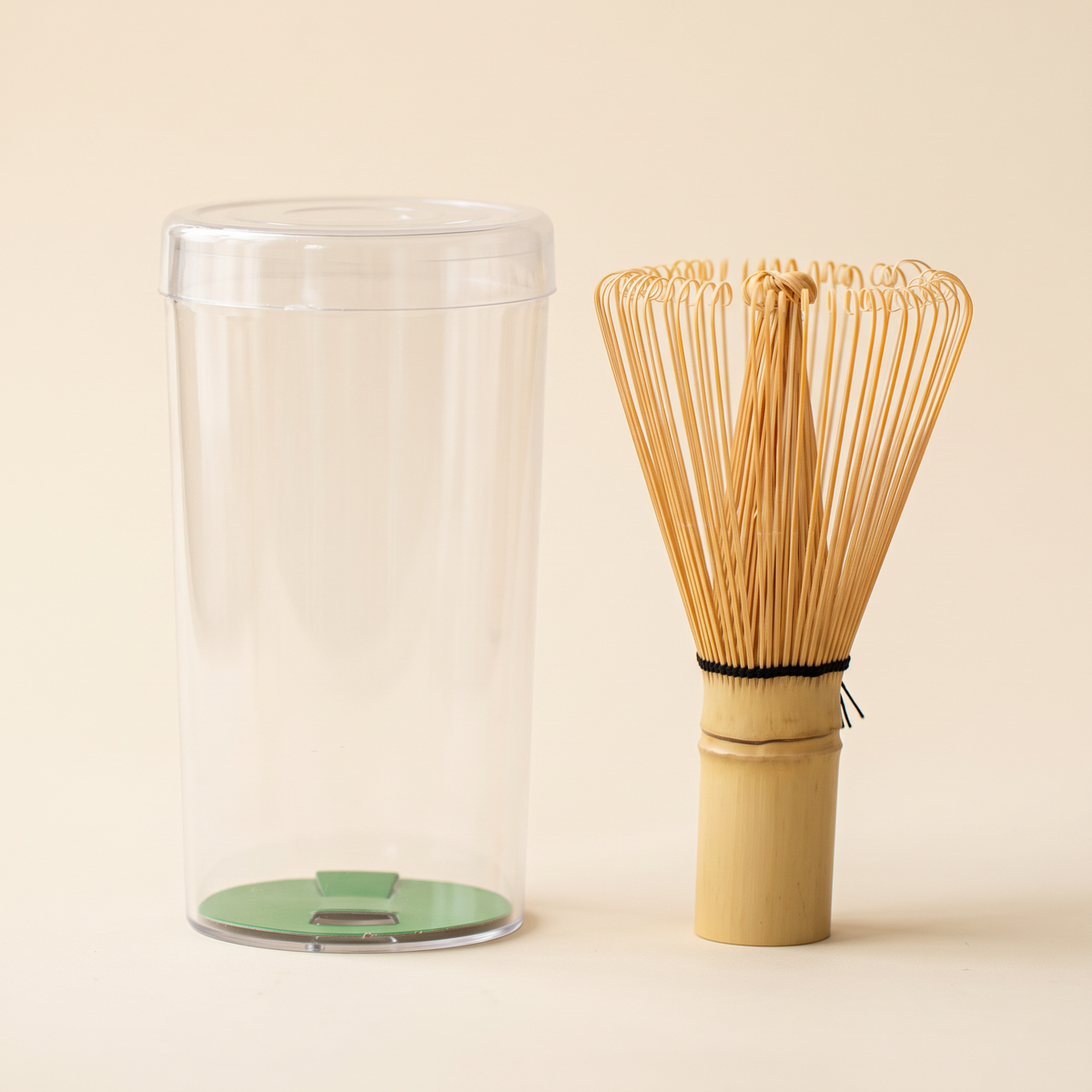What arrives: the 64-prong whisk beside its clear protective tube, shown without its label