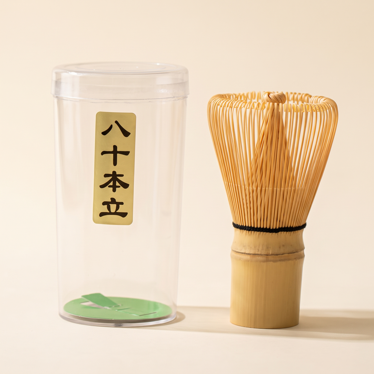 What arrives: the 80-prong whisk beside its clear protective tube, which carries a paper label with the prong count