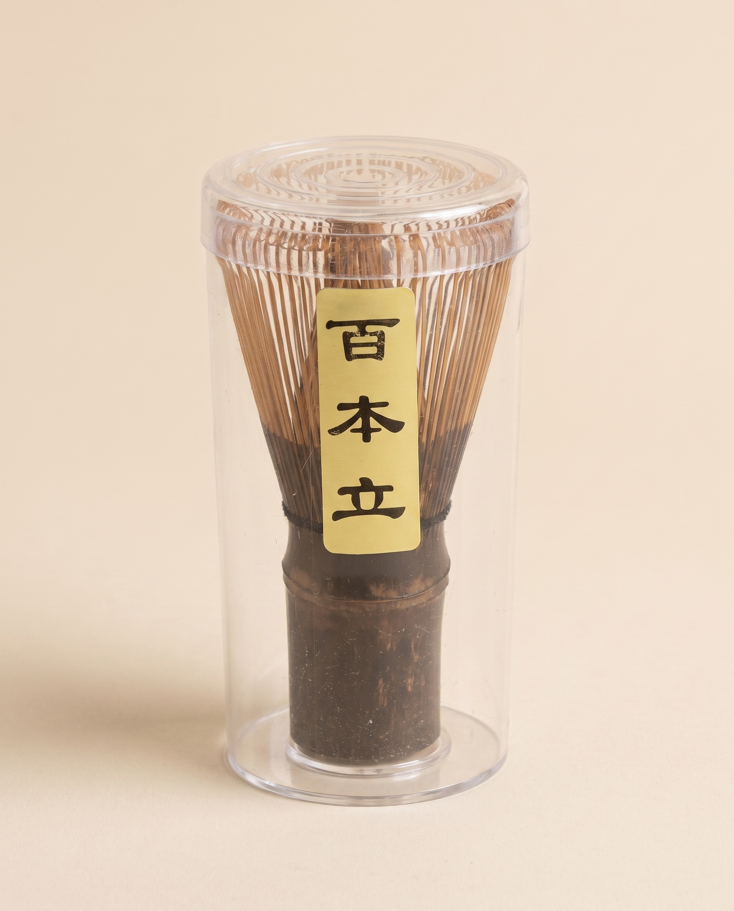 What arrives: the whisk in its clear protective tube, with the maker's paper label on the handle
