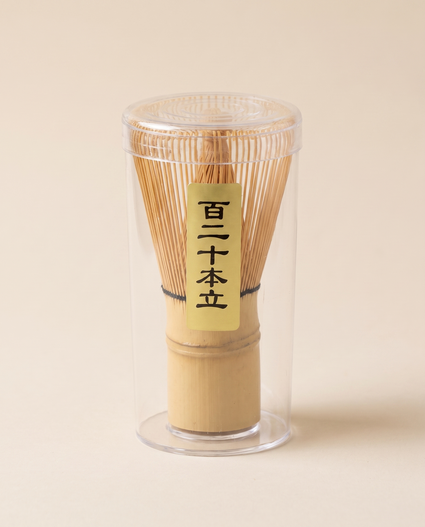 What arrives: the whisk in its clear protective tube, with the maker's paper label on the handle