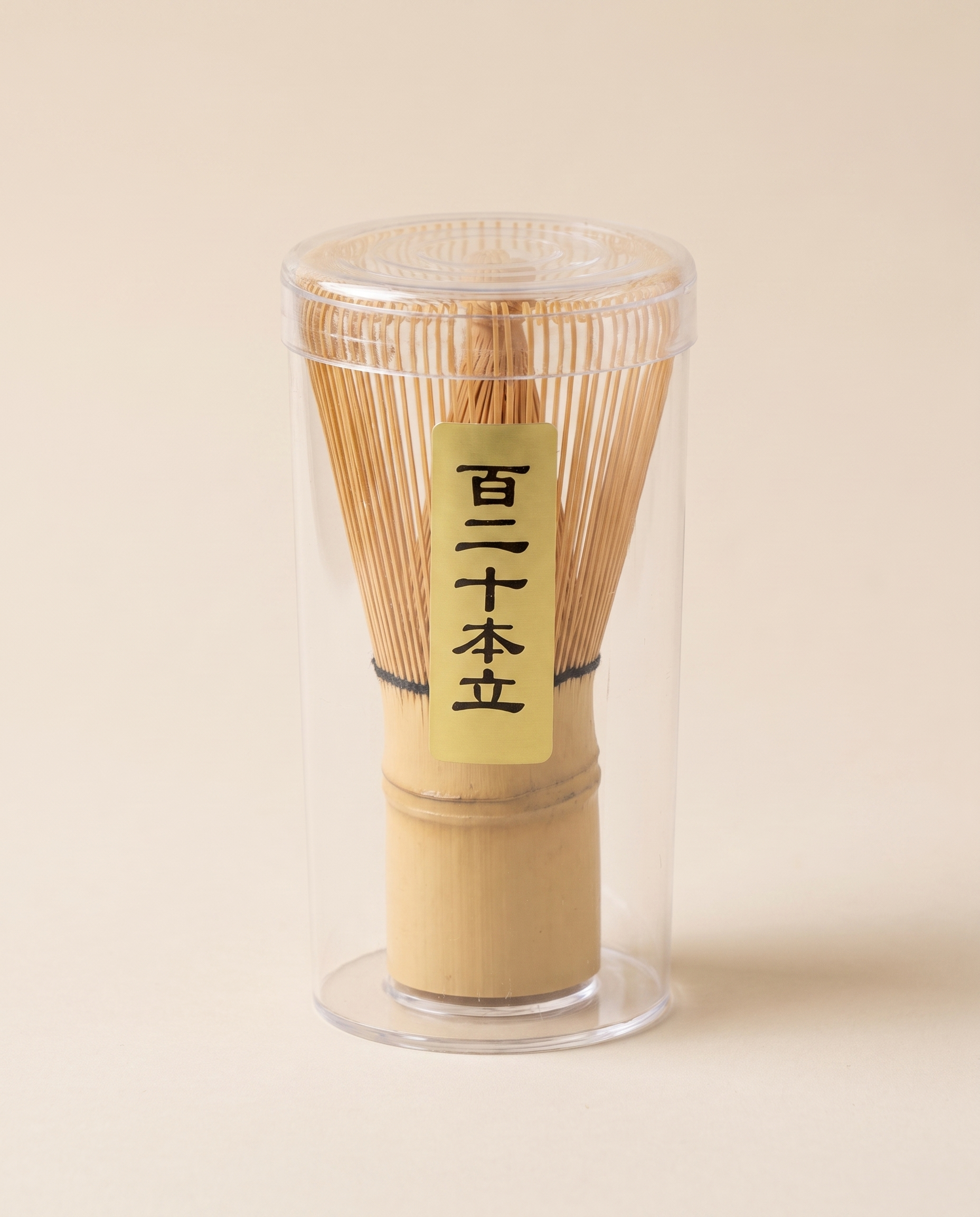 What arrives: the whisk in its clear protective tube, with the maker's paper label on the handle