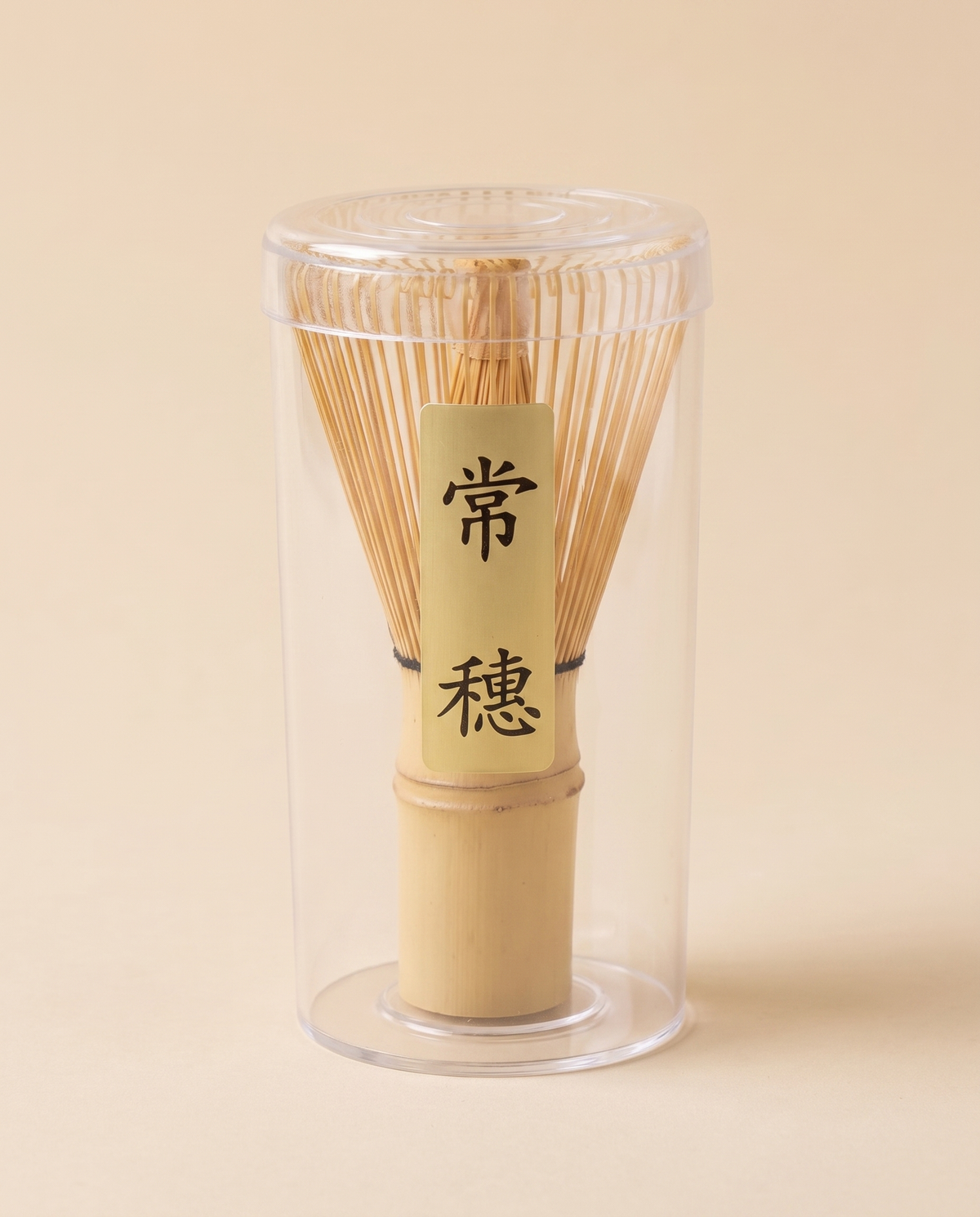 What arrives: the whisk in its clear protective tube, with the maker's paper label on the handle