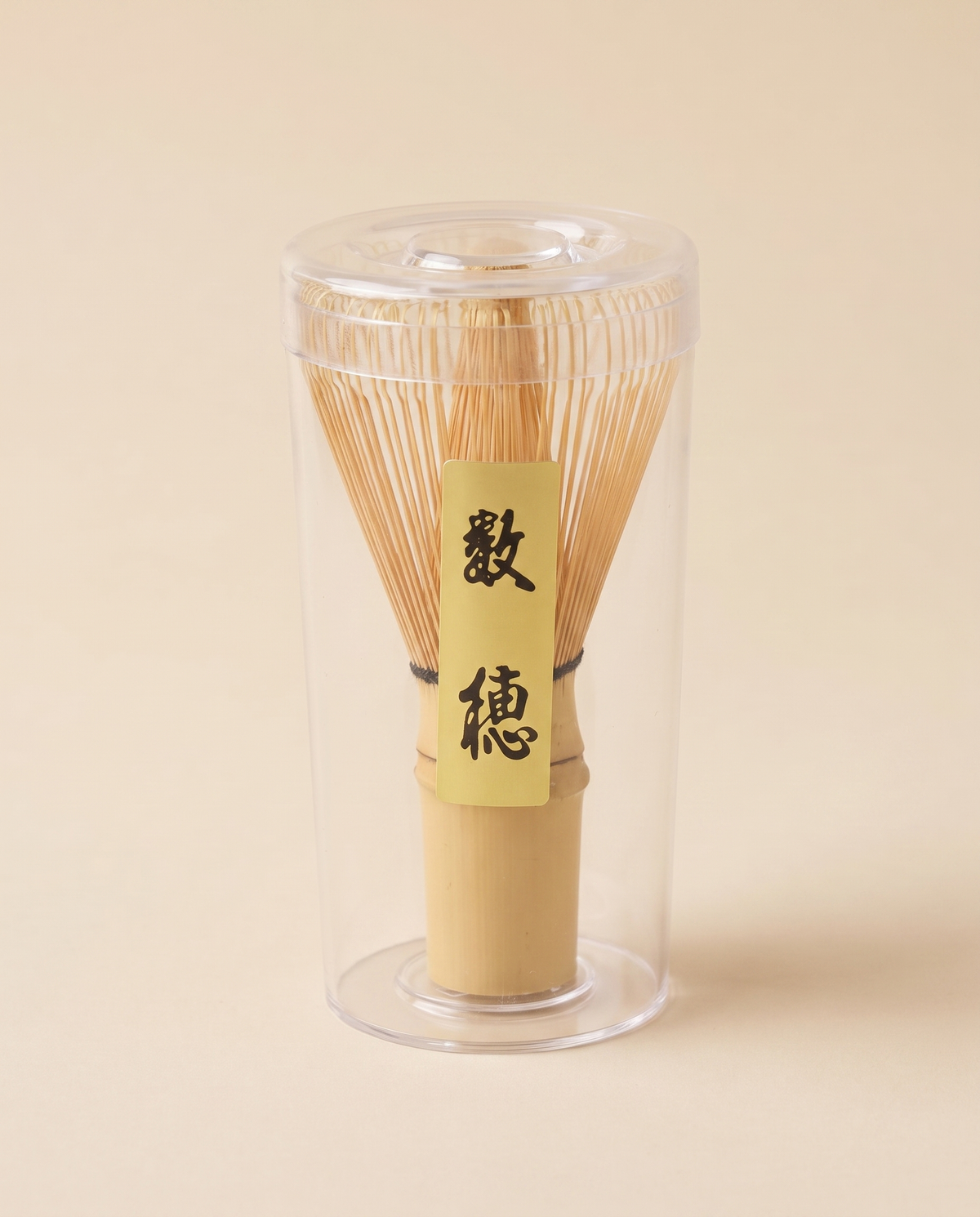 What arrives: the whisk in its clear protective tube, with the maker's paper label on the handle