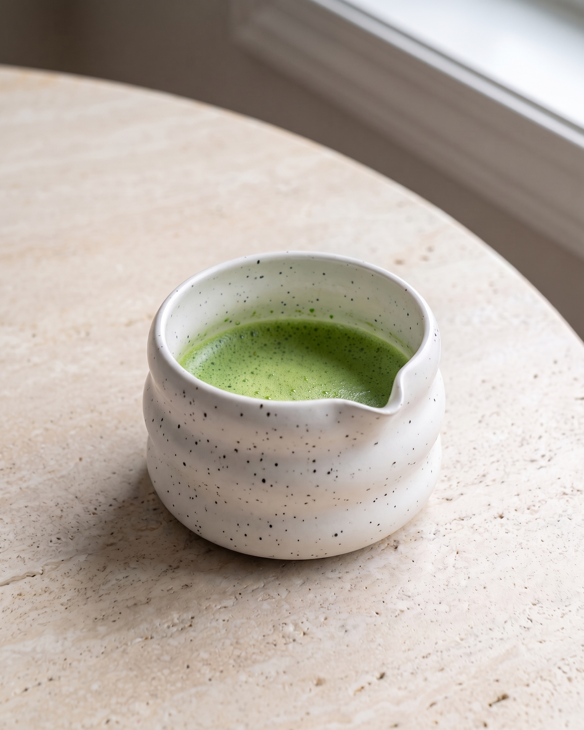 In use: Speckled Ceramic Matcha Bowl – White, filled with freshly whisked matcha