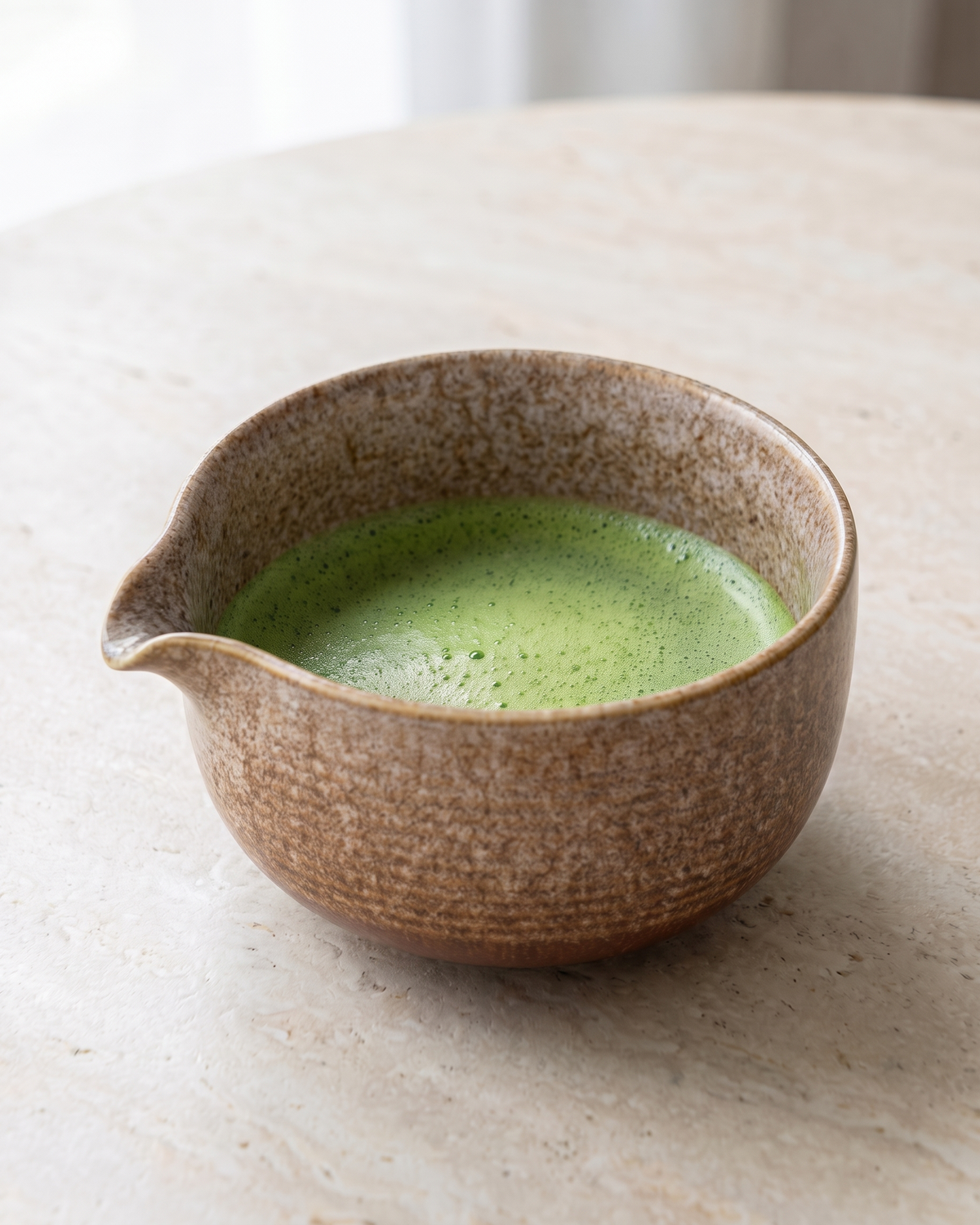 In use: Glazed Matcha Bowl 550 ml – Sand, filled with freshly whisked matcha