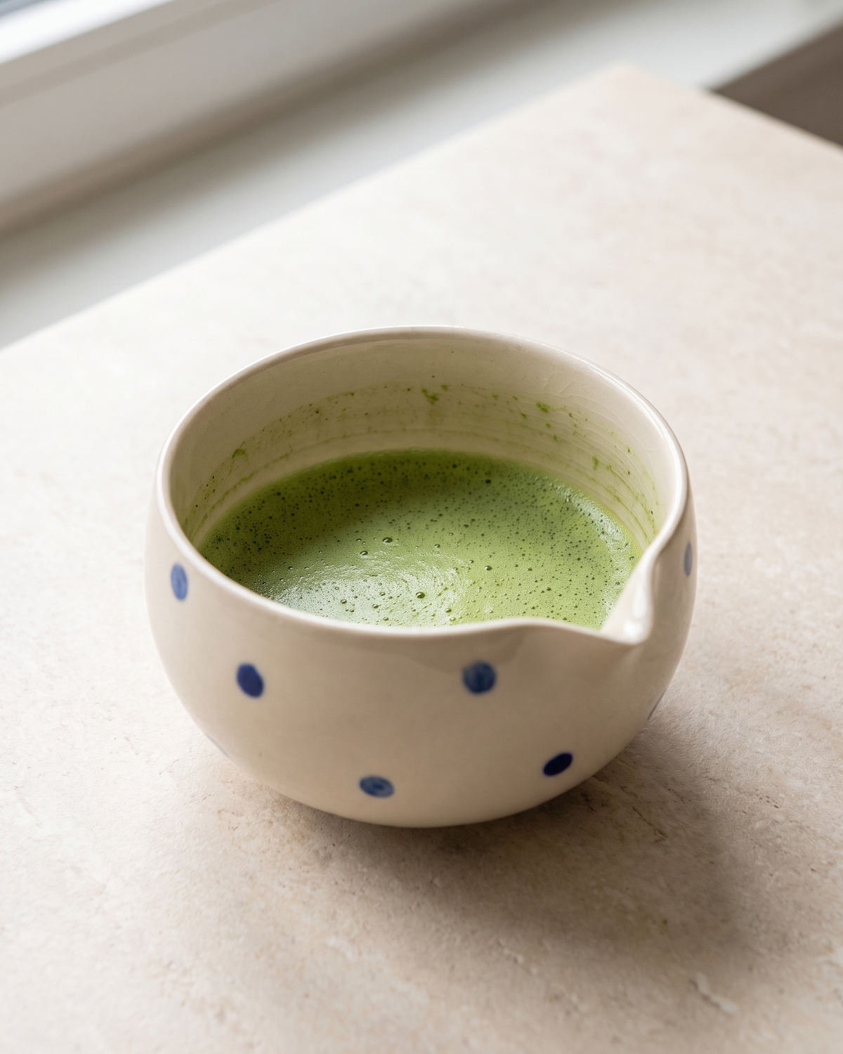 In use: Patterned Ceramic Matcha Bowl – Blue Dots, filled with freshly whisked matcha