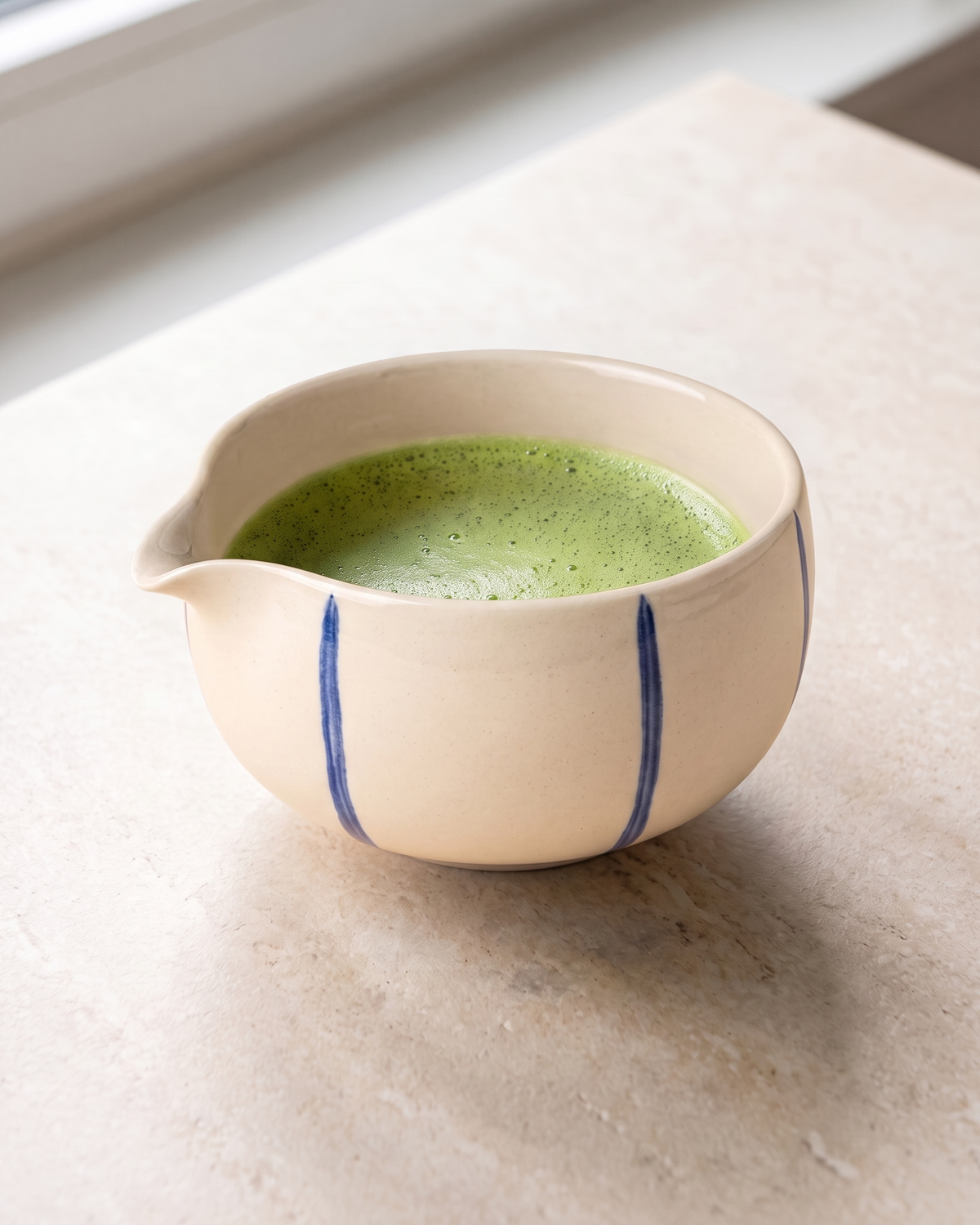 In use: Patterned Ceramic Matcha Bowl – Blue Stripes, filled with freshly whisked matcha