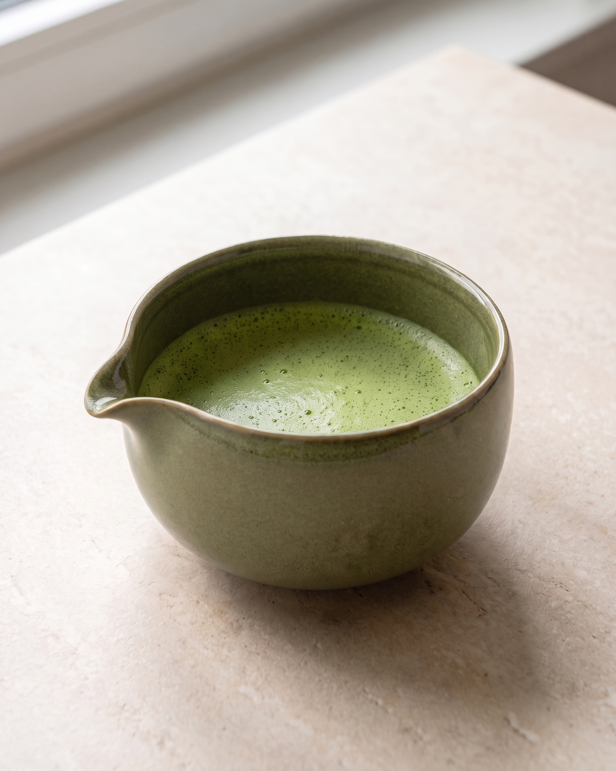 In use: Patterned Ceramic Matcha Bowl – Olive, filled with freshly whisked matcha