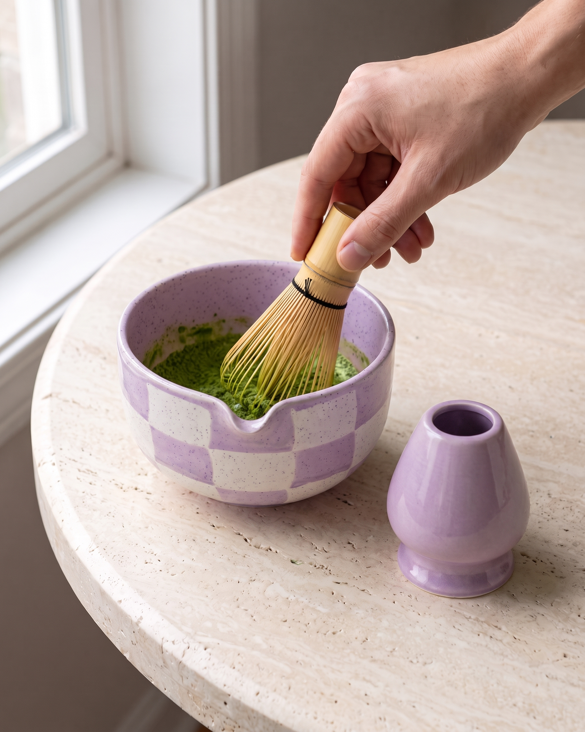 In use: 2-Piece Checkerboard Bowl & Holder Set – Purple, hand whisking matcha in the bowl with a bamboo whisk (sold separately), holder beside