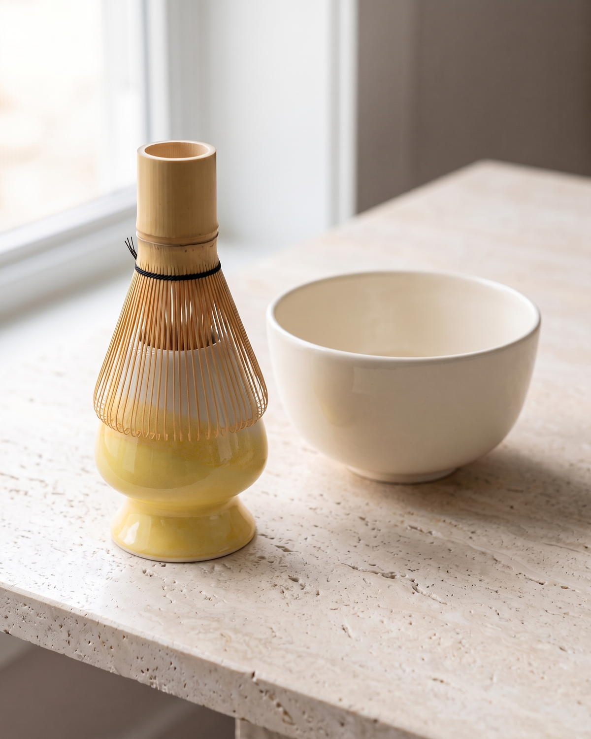 In use: Two-Tone Ceramic Whisk Holder – Yellow Dip, bamboo whisk resting prongs-down on the holder to dry