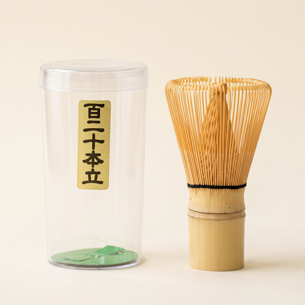 What arrives: the 120-prong whisk beside its clear protective tube, which carries a paper label with the prong count